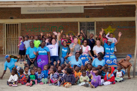 large group shot waving